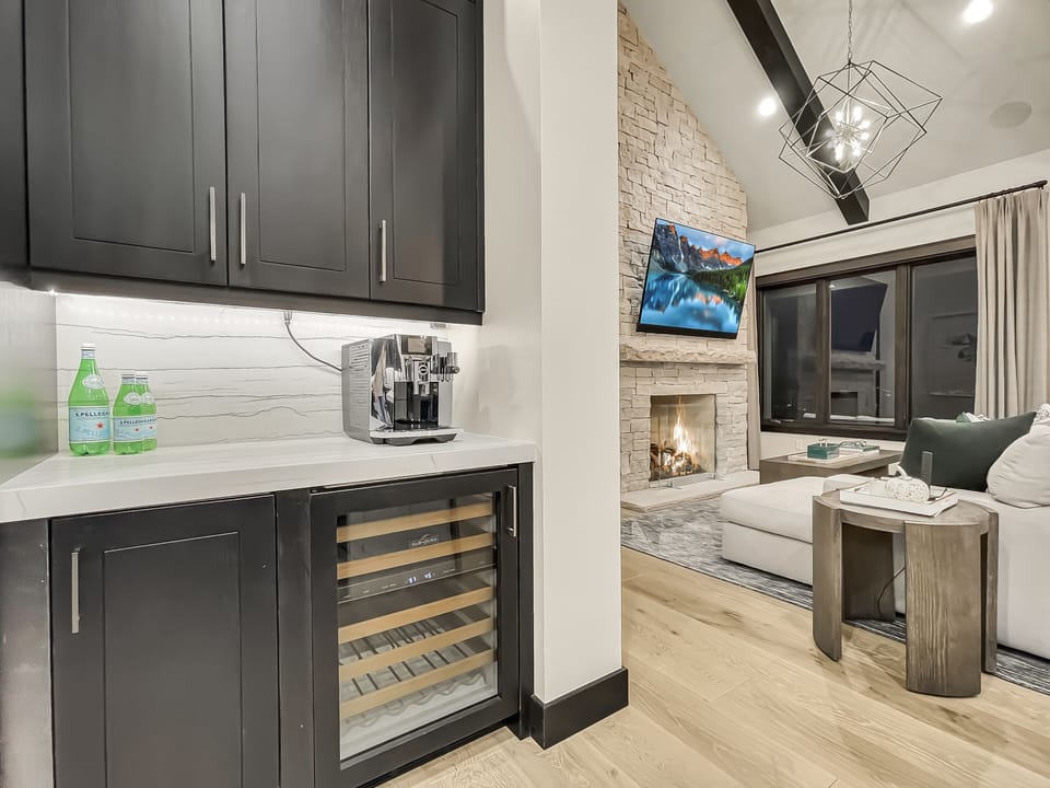 The kitchen features a drink bar with a Jura Coffee System and a wine cooler.