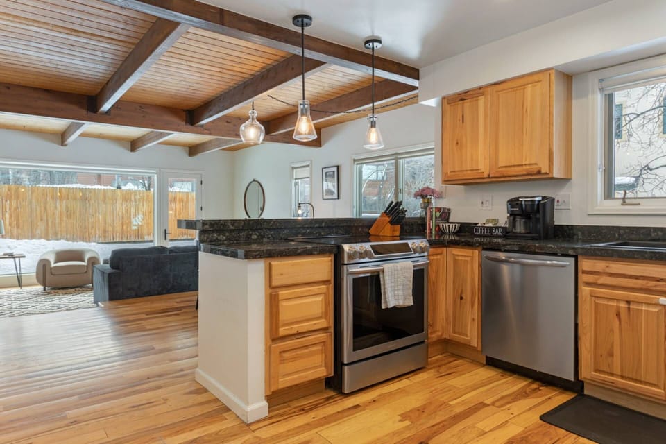 Where food and family come together - a kitchen that opens up to a welcoming dining and living area.