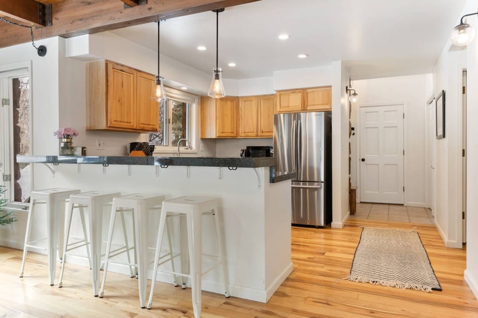 Enjoy casual dining and lively conversations at the kitchen bar, the perfect spot for a quick bite or morning coffee.