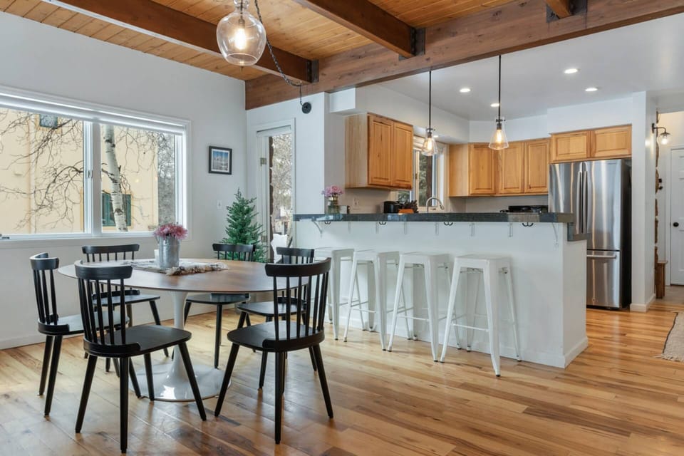 The dining area seamlessly connects to the kitchen, creating a welcoming space for shared meals and lively conversations