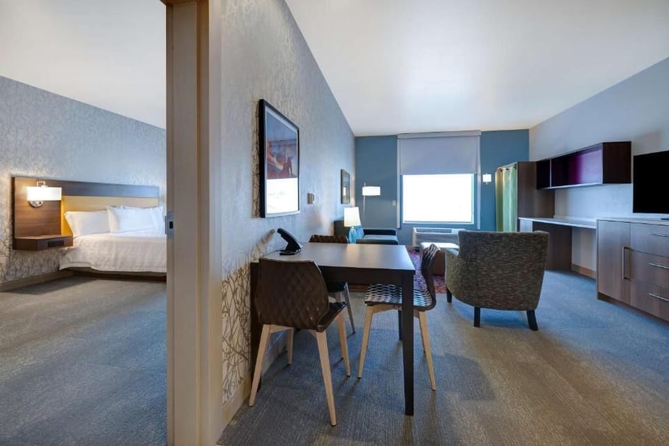 Gather for drinks at the dining table beside cozy lounge seating.