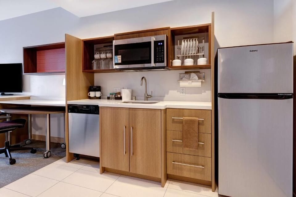 Feel at home with a sleek kitchenette and dining-ready setup.