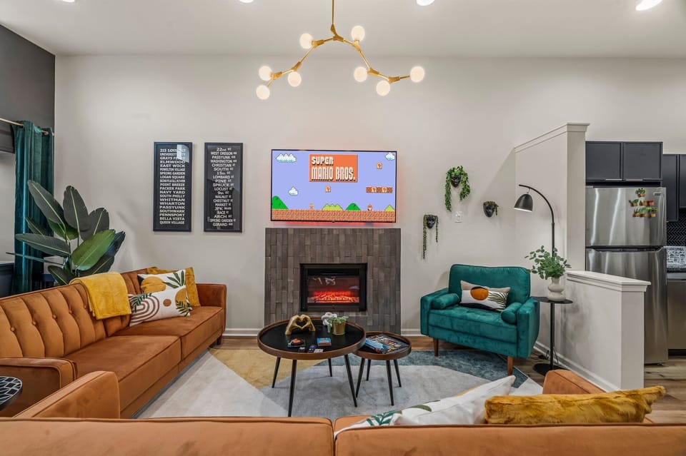Unwind by the glow of the fireplace while enjoying your favorite show in this vibrant, stylish lounge.