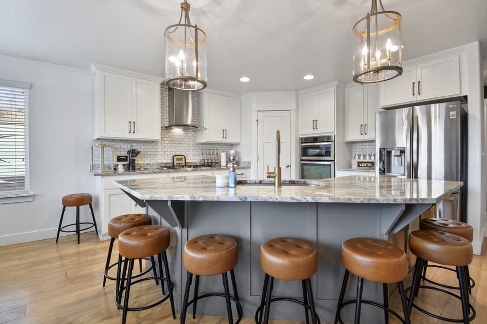 A fully equipped chefs kitchen with massive island that seats 6, plus a dining table that seats 12 for a total of 18 in the kitchen dining area.