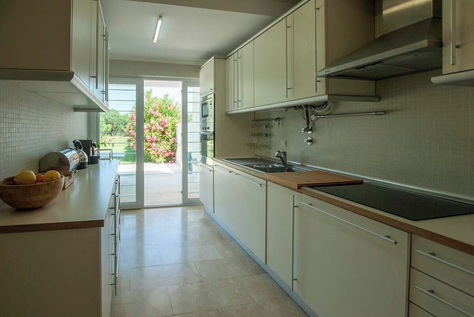 Modern galley kitchen with garden access — Villa Linda, luxury holiday villa in Sesimbra