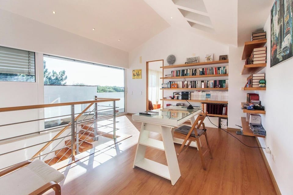 Modern home office with wooden shelving and natural light — Villa Comporta, luxury holiday villa in Alcácer do Sal