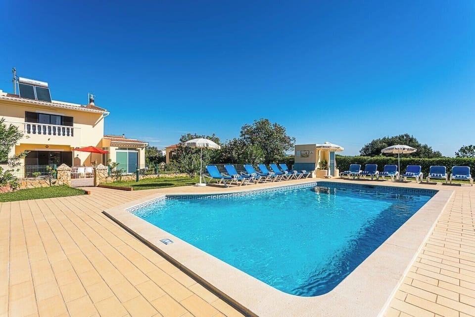 Swimming pool surrounded by a large garden.