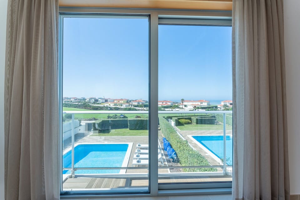 View from bedroom with private pool and manicured gardens — Villa del Rey VIII, luxury holiday villa in Óbidos