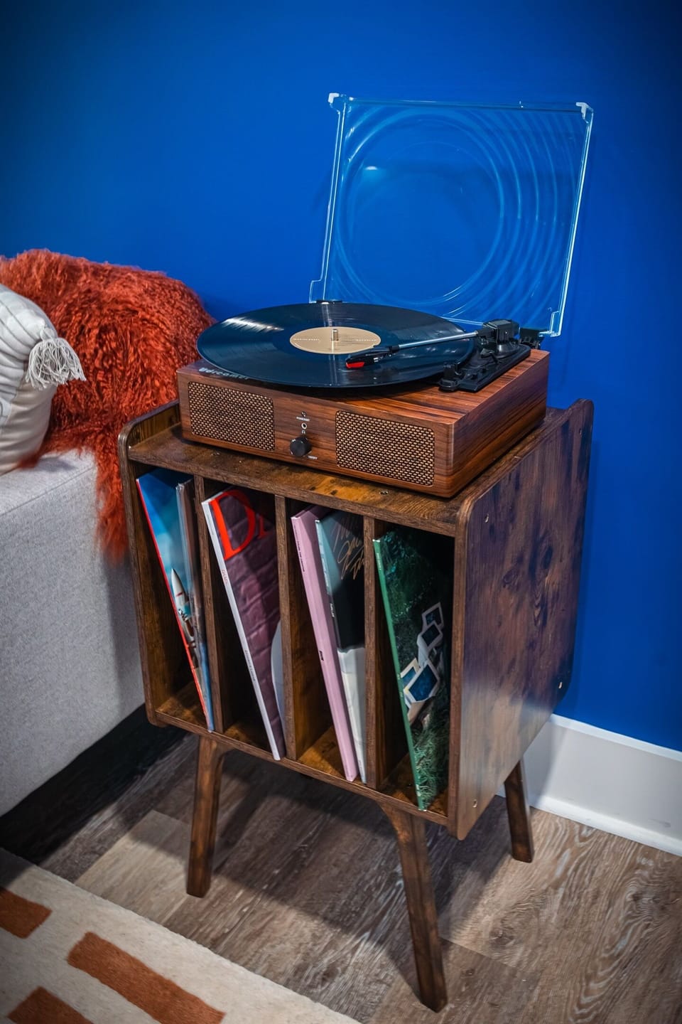 A close-up of the record player and its eclectic vinyl collection, inviting guests to spin some tunes and step back in time.