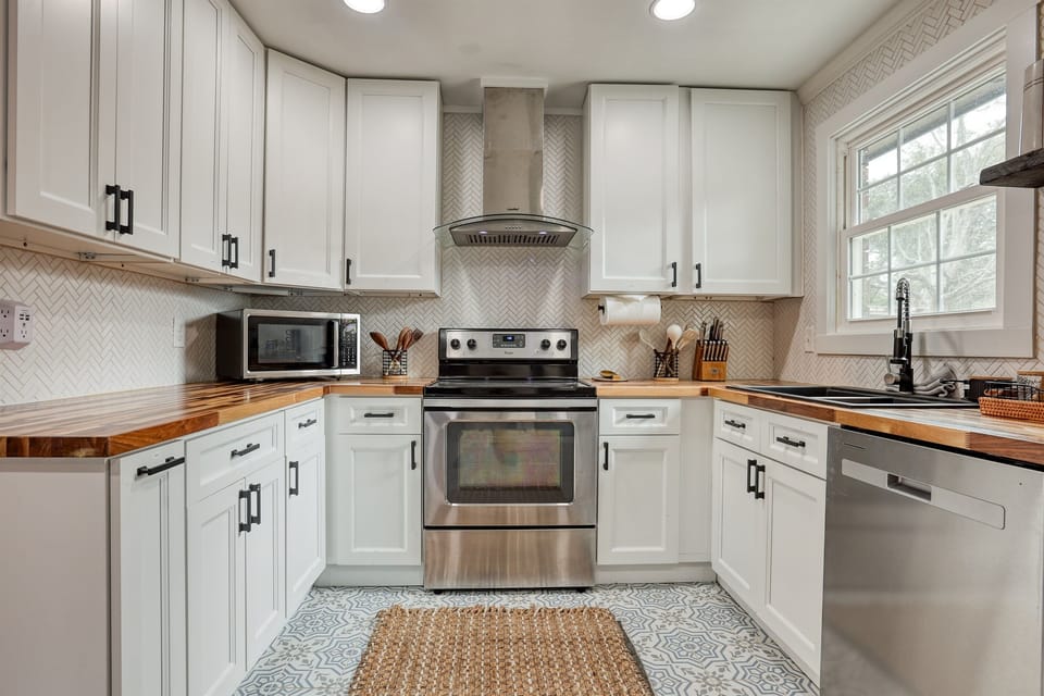 Close-up of the kitchen's cooking area, highlighting the modern stainless steel appliances and ample counter space for meal preparation.