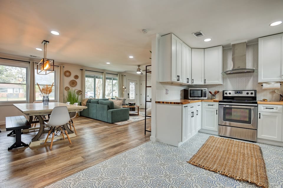 The open-plan dining area adjacent to the kitchen, showing a large table set for a family meal, seamlessly integrates style and function.
