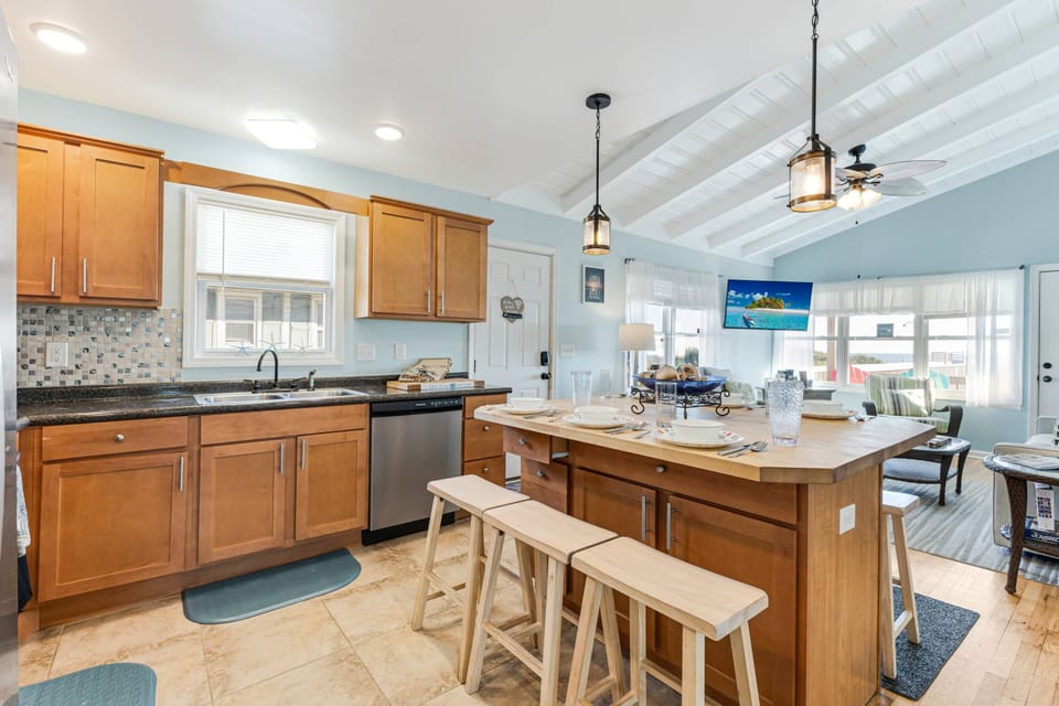 Dividing the kitchen & living areas is an island with plenty of storage & seating for 6. Choose alfresco dining on the deck.
