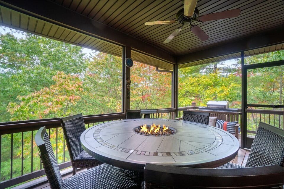 Ground floor patio with firepit, outdoor seating, and grill