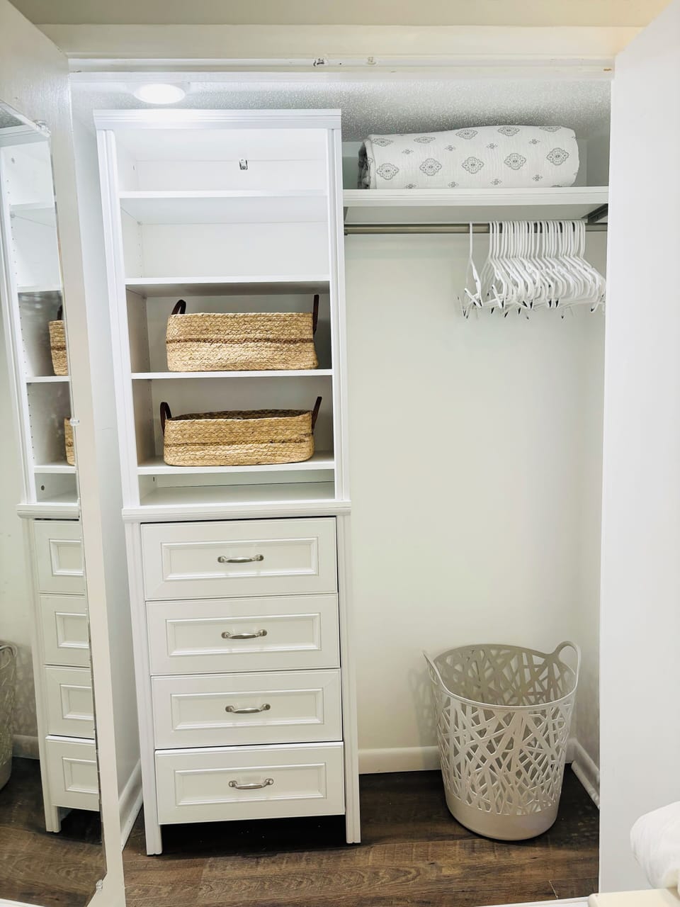 Master bedroom has built-in closet with drawers, shelves, hangers, and hamper.