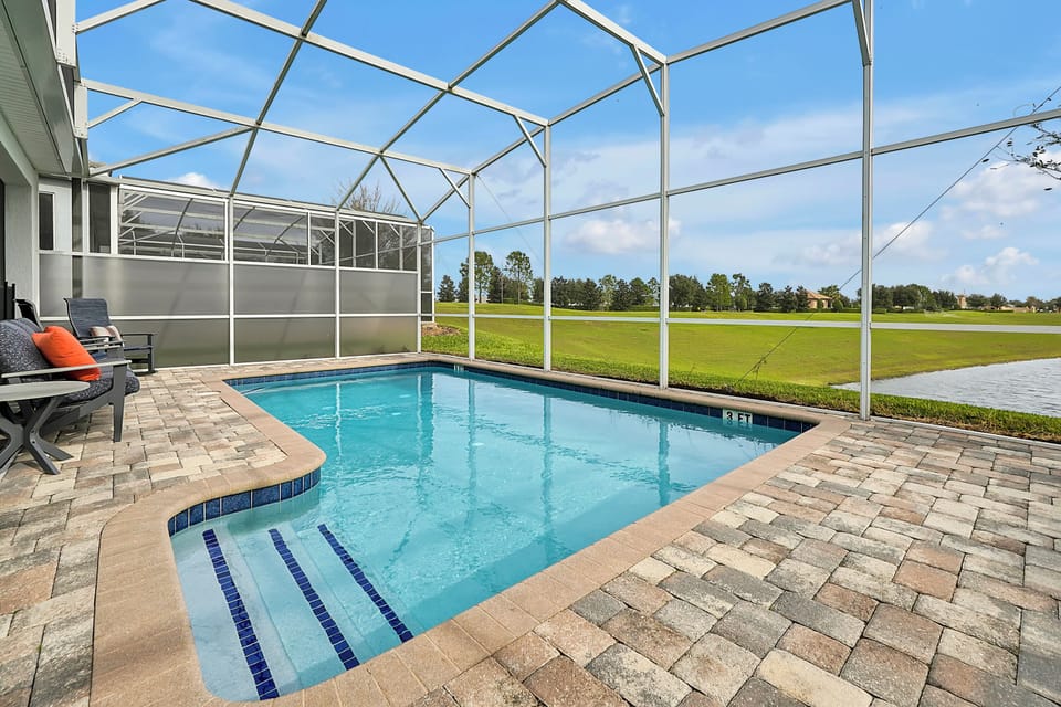 Private screened pool with no rear neighbors—perfect for quiet mornings or post-park relaxation.