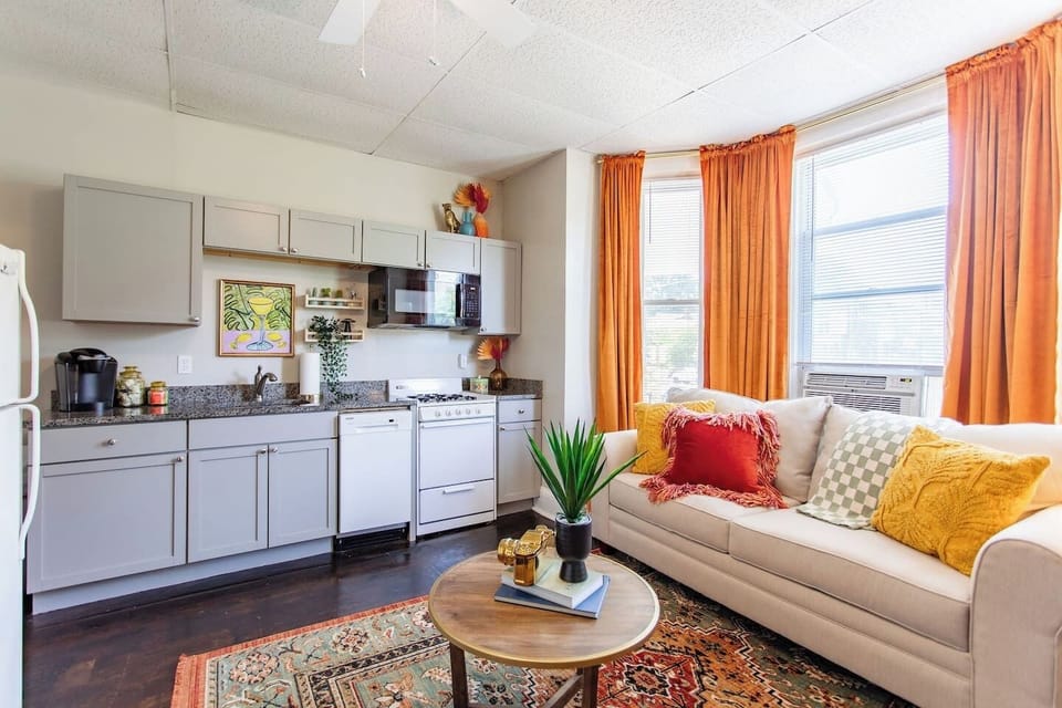 Open living area with the kitchen conveniently located on the side, creating a spacious and functional layout for both relaxation and meal preparation.