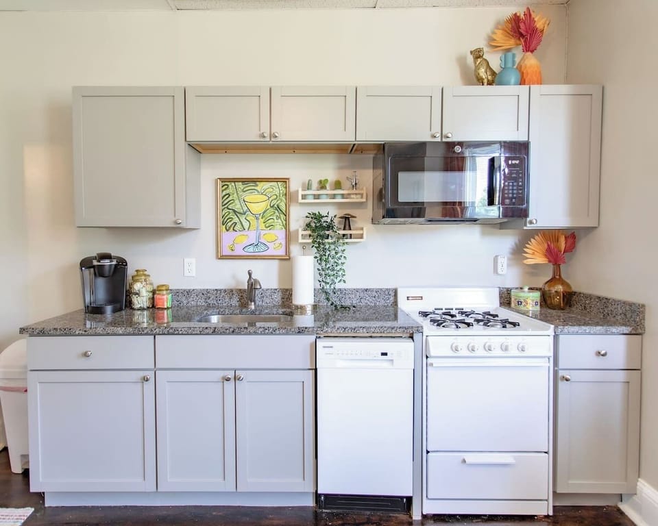 Fully equipped kitchen with modern appliances, including a stove, oven, refrigerator, microwave, and all the cookware and utensils you need to prepare and enjoy your meals.