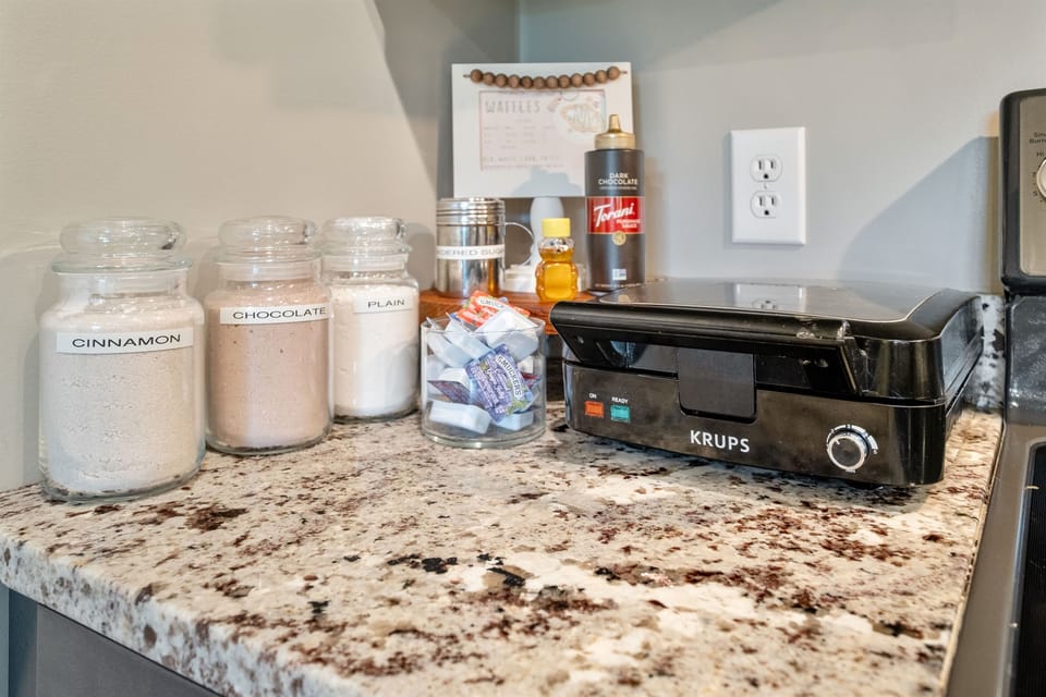 Indulge in the delightful waffle/pancake bar experience featuring an array of flavored waffle mixes and a tempting selection of toppings – your taste buds are in for a treat!