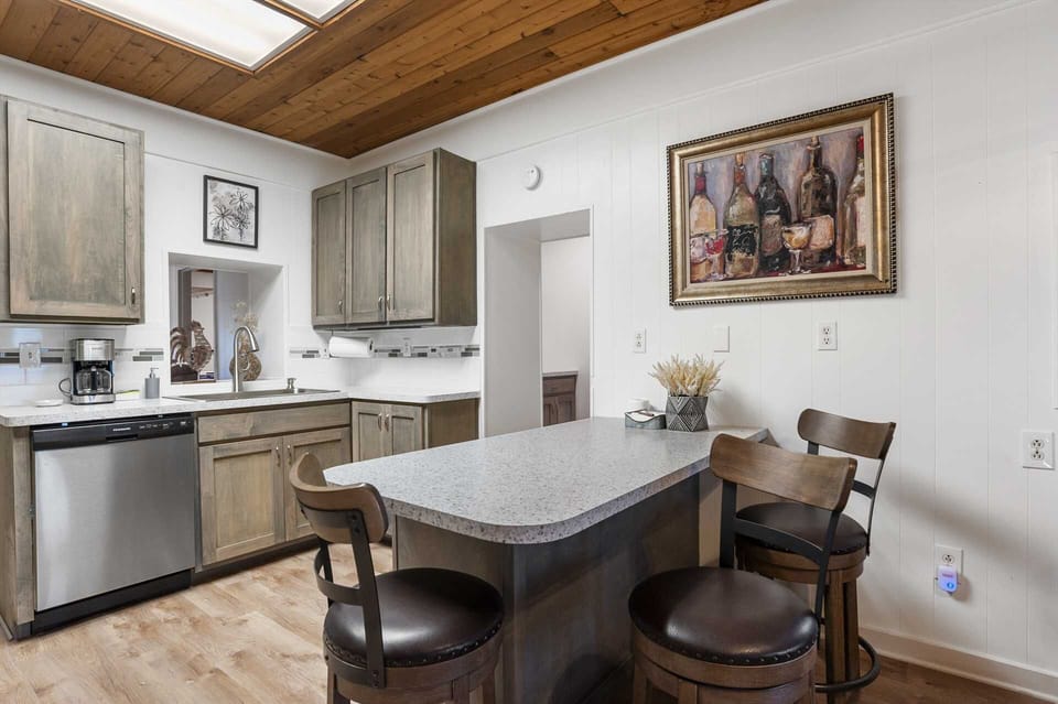 Bar-style seating offers comfort and convenience at mealtimes, handily located between the kitchen and living area.