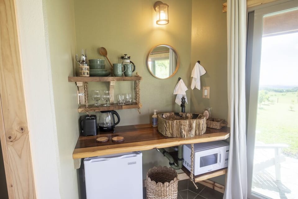 Beautiful kitchenette with a unique petrified tree sink and microwave