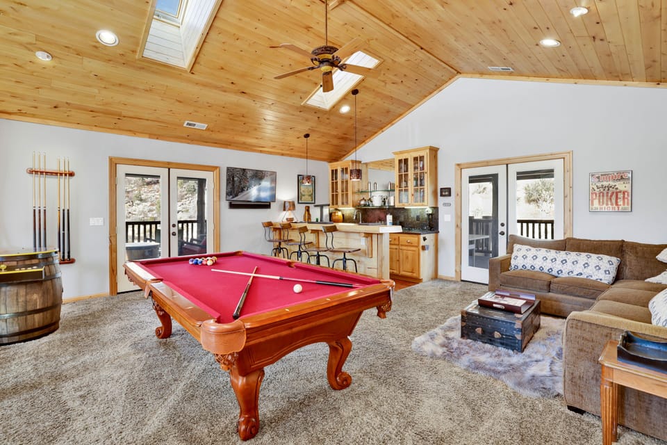 A fun game room with games perfect for family fun, friendly competition, and unforgettable entertainment during your stay. The space also features comfy seating and a TV, making it a great spot to relax and enjoy time together.