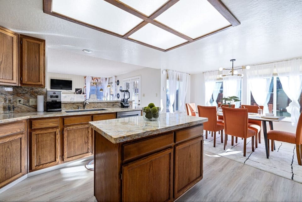 Wooden kitchen, bright skylight, dining area.