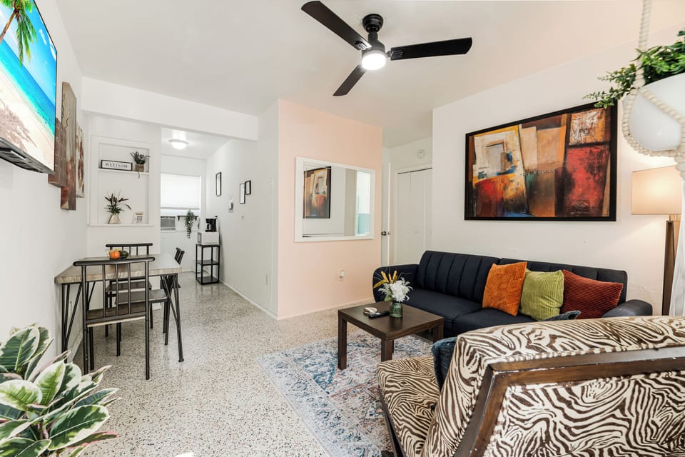Spacious living room with a futon and plenty of natural light. 