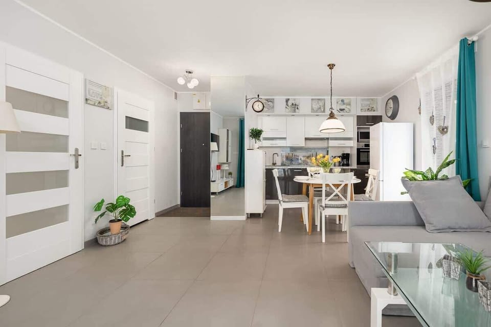 The living area features a sleek coffee table and a flat-screen television.