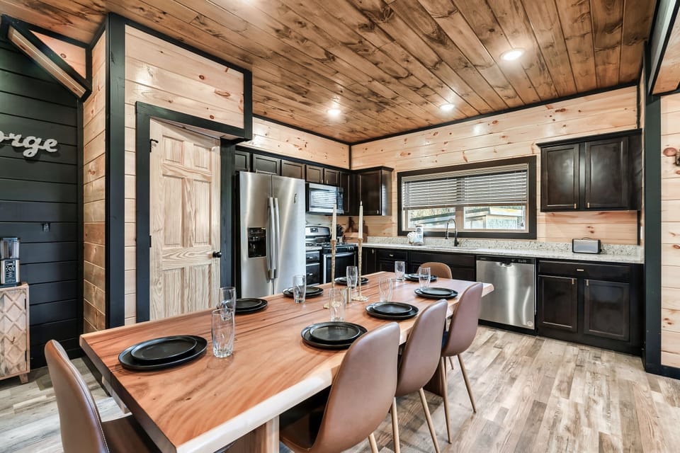 Long dining table that comfortably seats eight in a fully equipped kitchen