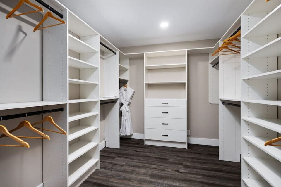 Stay organized with this spacious walk-in closet featuring plenty of shelving and room for all your essentials.