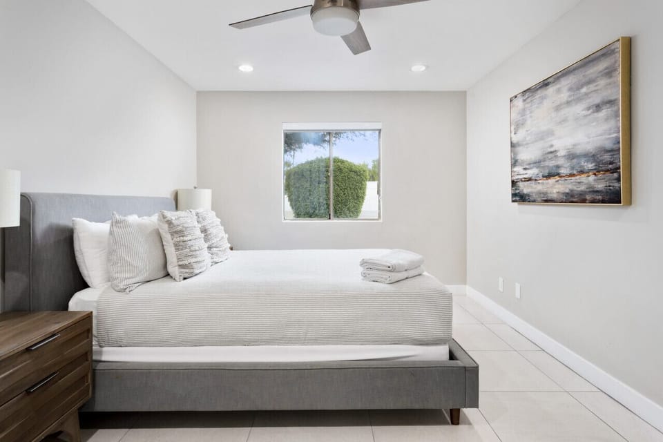 Simple and cozy bedroom with fresh linens and natural light.