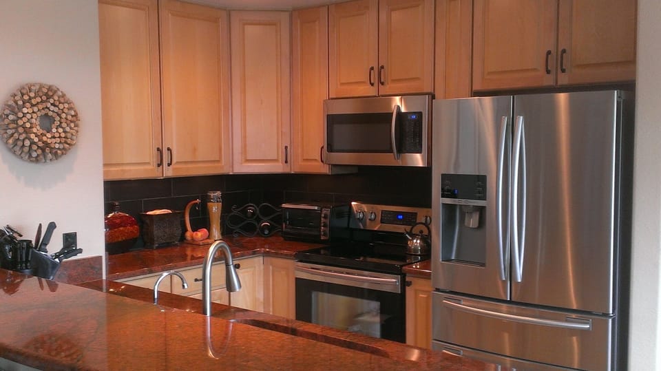 Kitchen features high end slab granite, pull out shelves