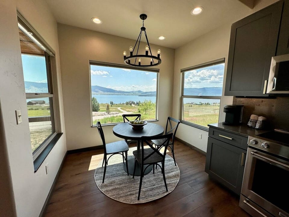 Large windows surround the small dining table, making you feel closer to nature.