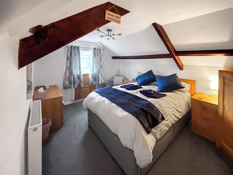 Beacon Cottage bedroom with king size bed and garden view | Beacon - High Peak House, Ravenscar, near Whitby