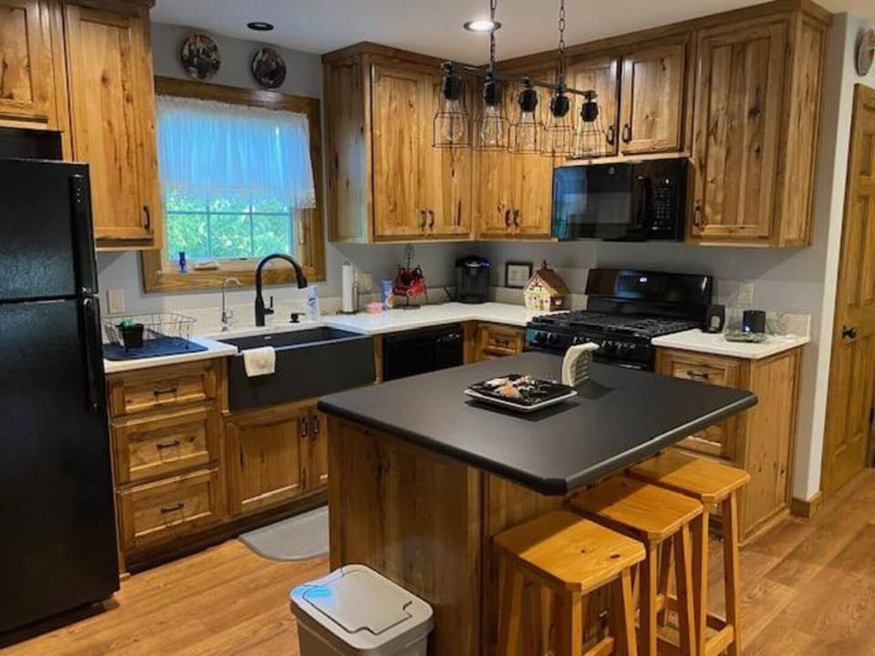Kitchen stocked with pots, pans, cutlery and dishes