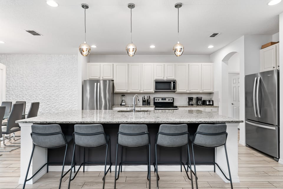The fully equipped kitchen features stainless steel appliances.