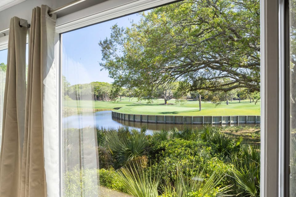 The floor to ceiling windows flood the villa with natural light, and let you gaze out to the golf course and lagoon.
