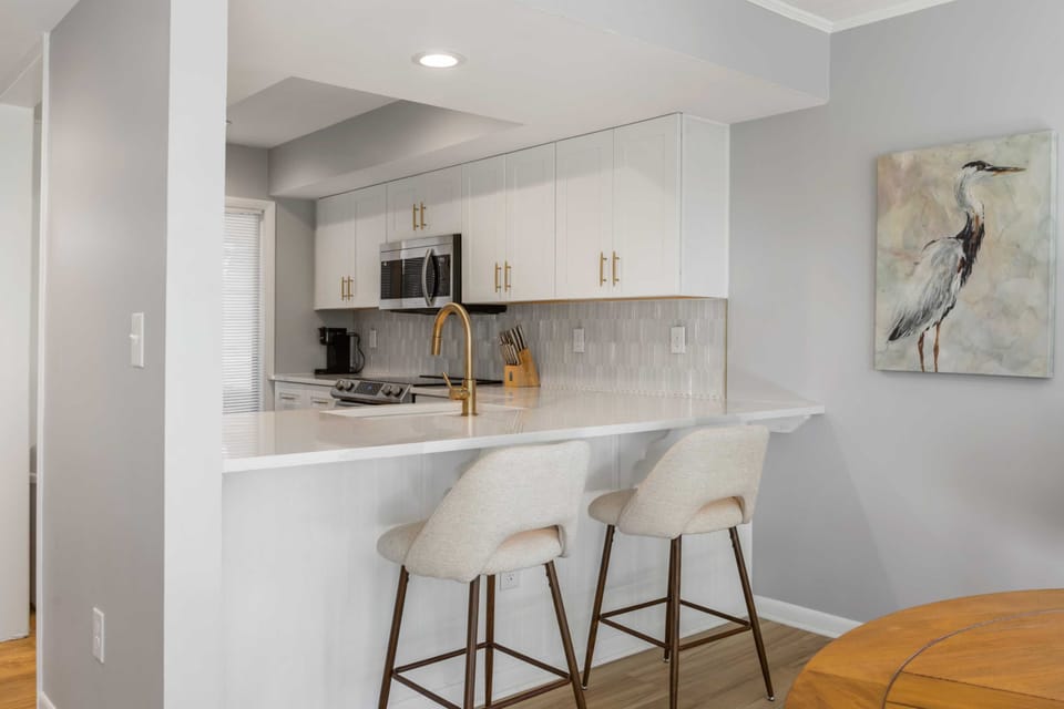 The kitchen breakfast bar has additional seating.