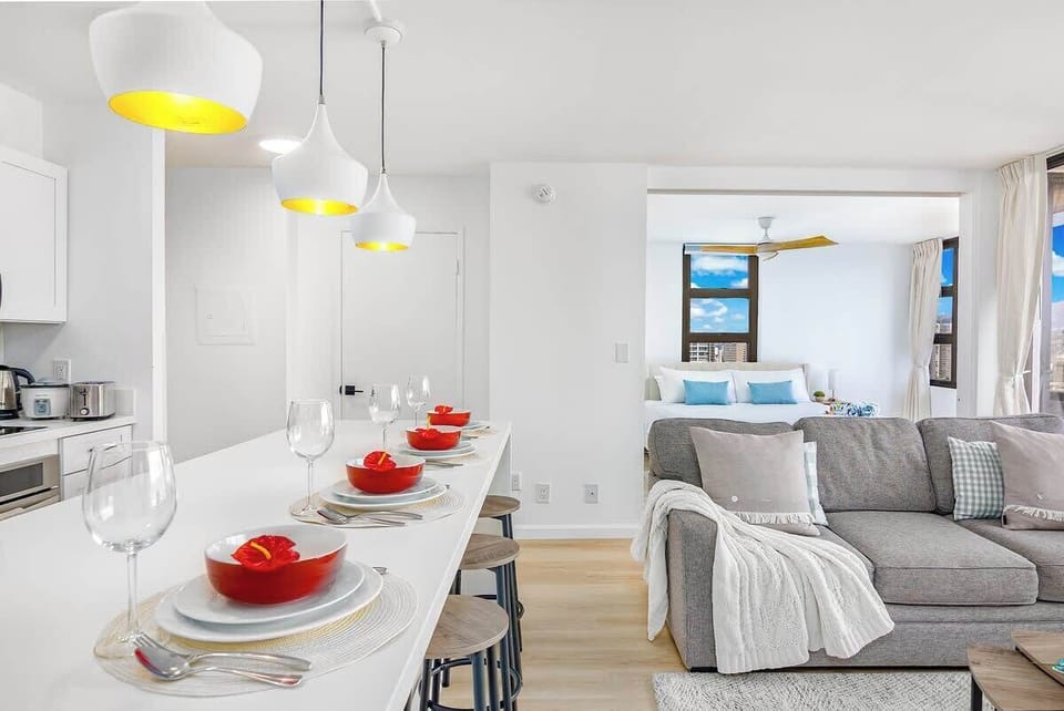 A bright, open-concept space that seamlessly connects a modern kitchen with a cozy living area, perfect for effortless entertaining.