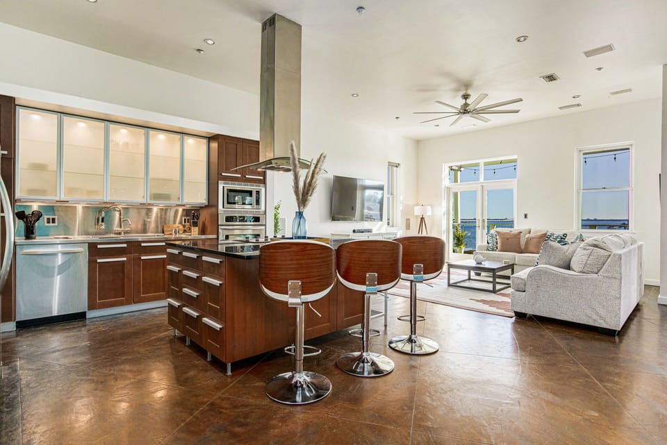 Modern and fully-equipped, the kitchen's barstools invite you to sip, chat, and savor every meal.