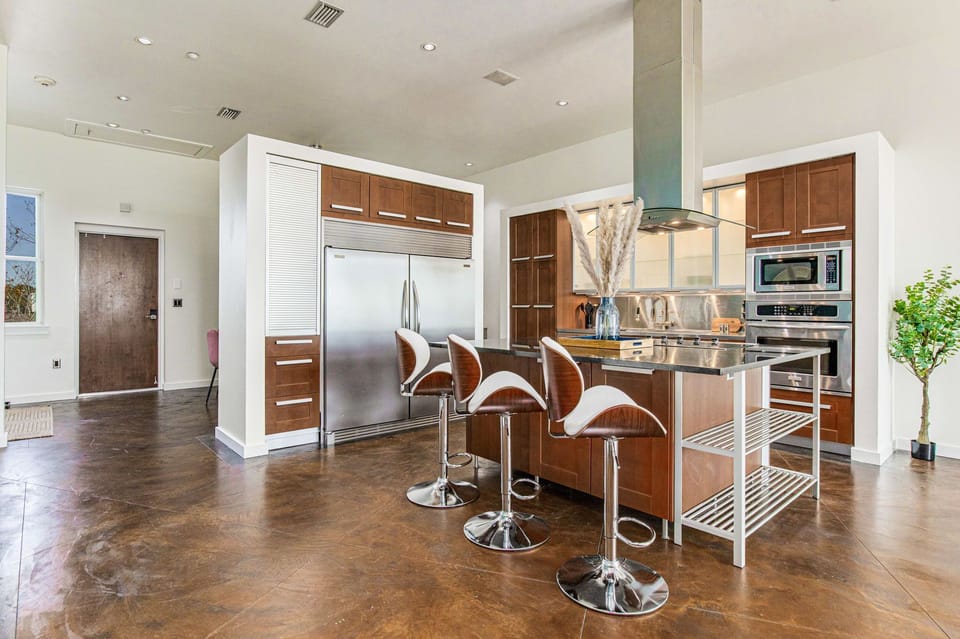 Enjoy the convenience of a kitchen stocked with cooking essentials, featuring a massive refrigerator and freezer to store all your treats.