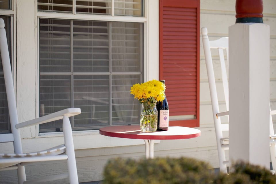 Enjoy a serene evening sipping wine on the front porch rocking chair of this charming vacation home in Gruene.