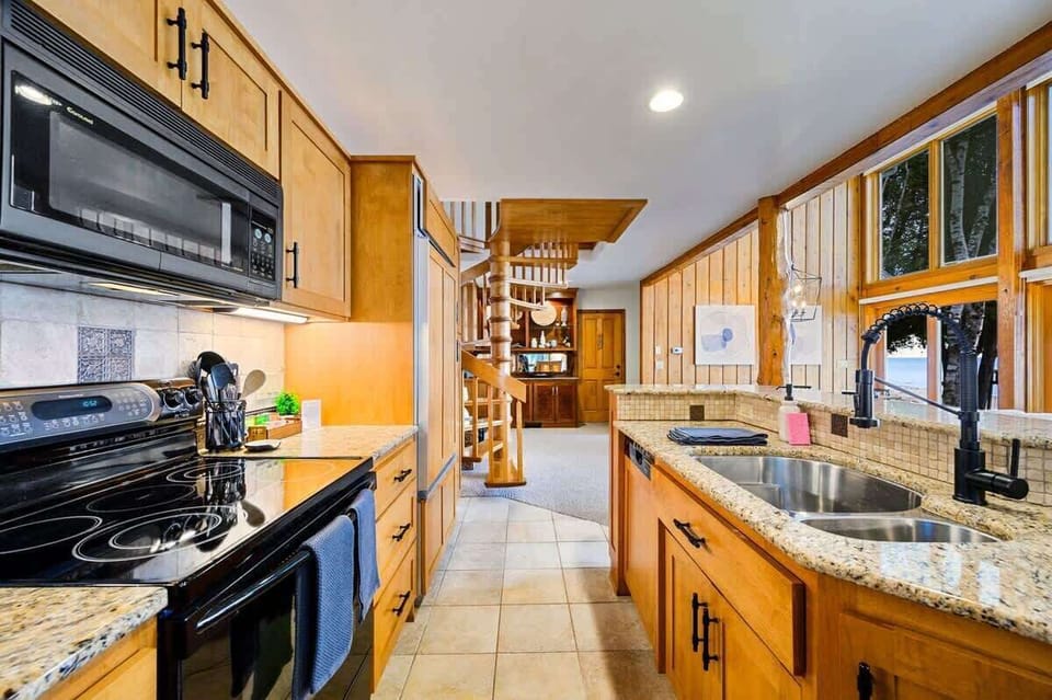 Featuring a sleek electric range and stove, this kitchen is prepped and ready for your culinary adventures. Luxury meets convenience with the state-of-the-art Sub-Zero built-in fridge/freezer, ensuring your ingredients stay fresh in style.