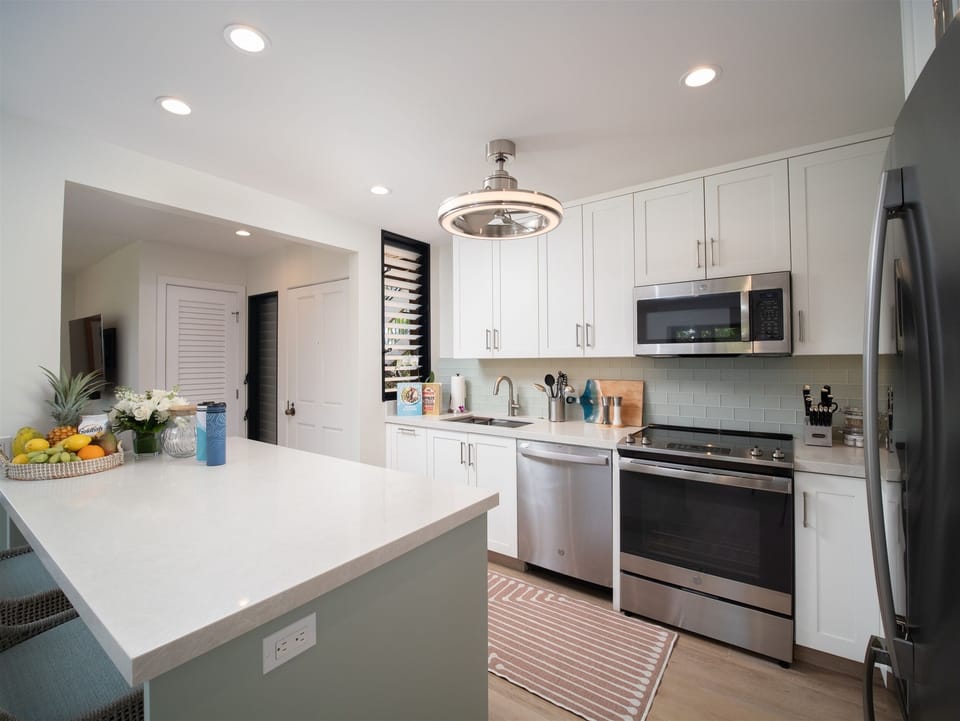 Newly remodeled kitchen and dining for four with bar seating direct lanai access