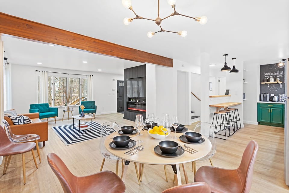 The airy flow from the dining area to the living room makes this space perfect for entertaining, with warm textures and modern design elements.