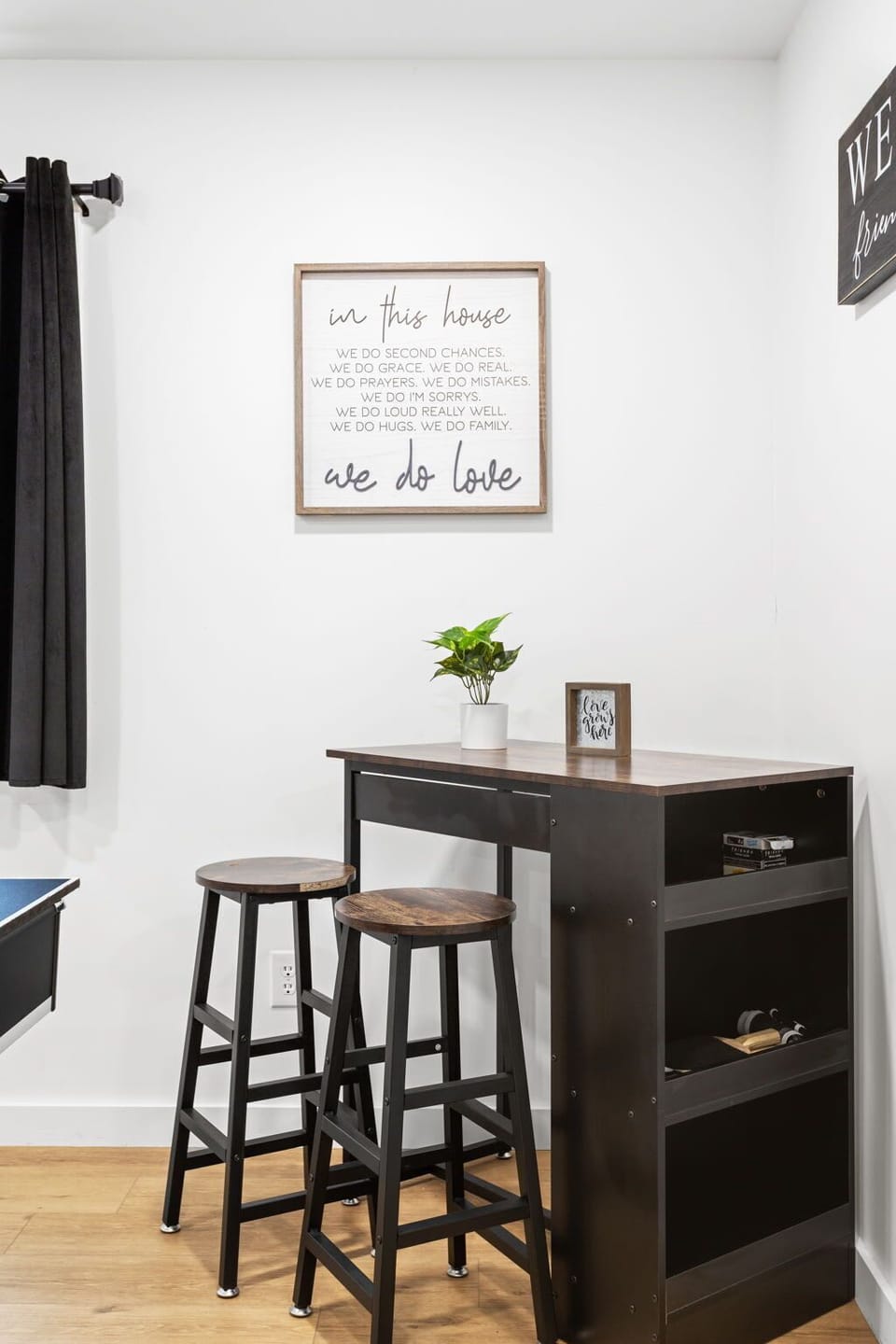A thoughtfully designed corner with a bar-height table and stools, creating the ideal spot to take a break between games and enjoy a drink.