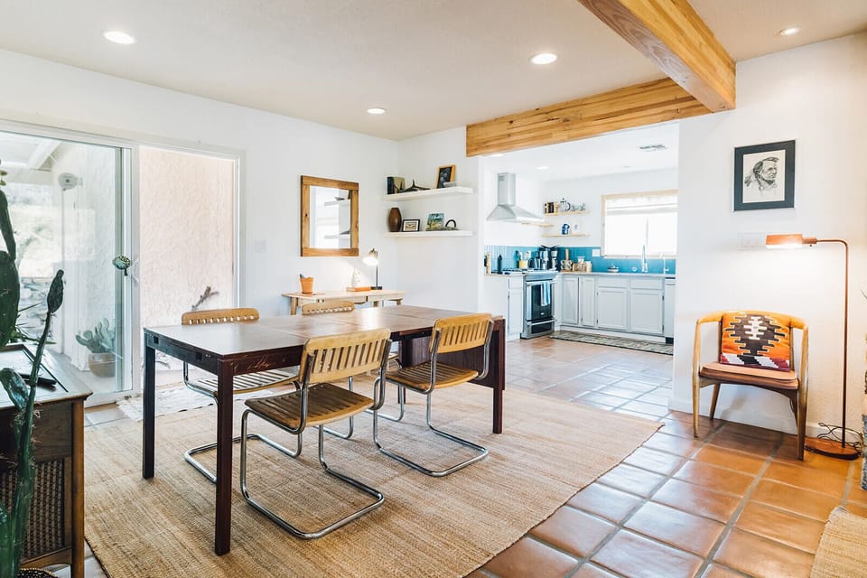 Gather around the dining table and enjoy a meal with friends and family. The open-concept layout allows for easy conversation and socializing between the kitchen, dining room and living room.