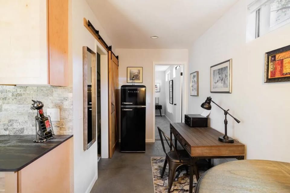 Kitchenette with retro fridge, a workspace with printer, lighting, and outlets. 