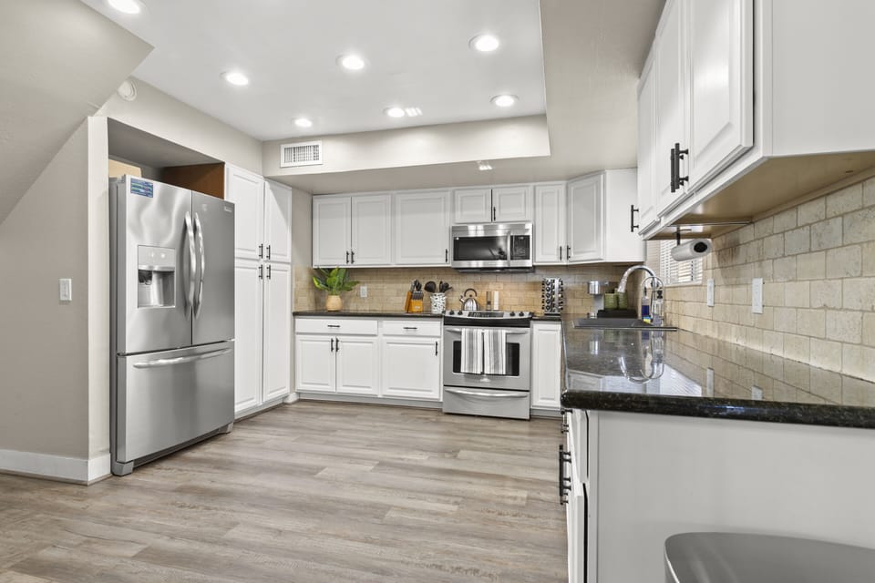 The kitchen is equipped with base cabinets and ample cupboards