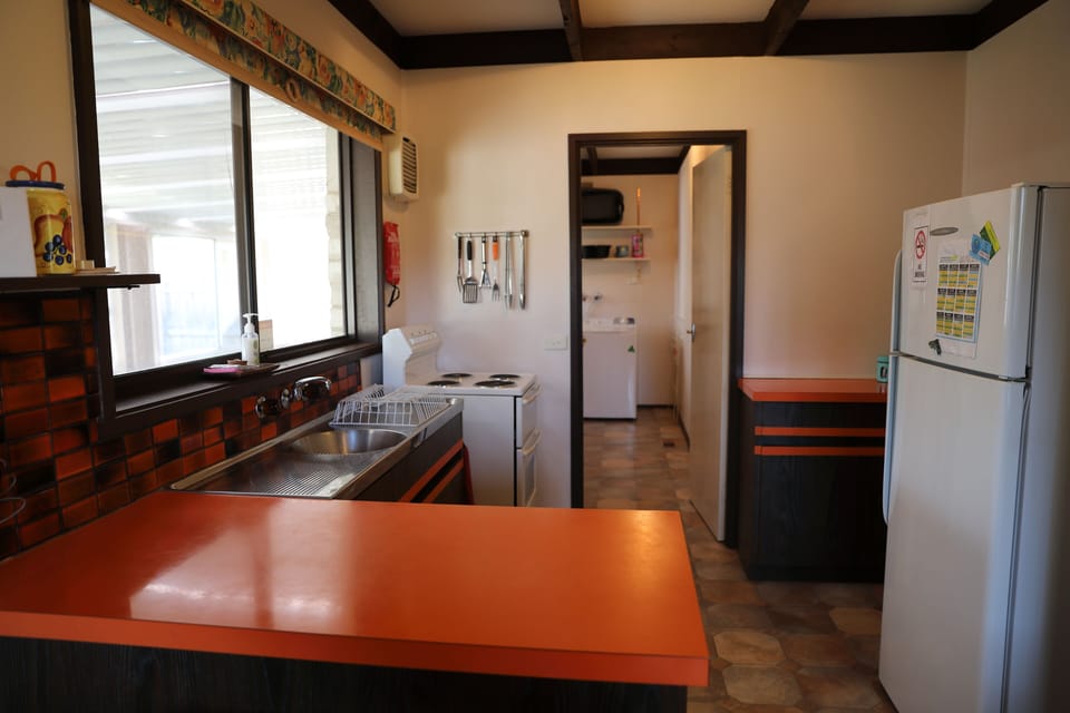 kitchen with laundry in background